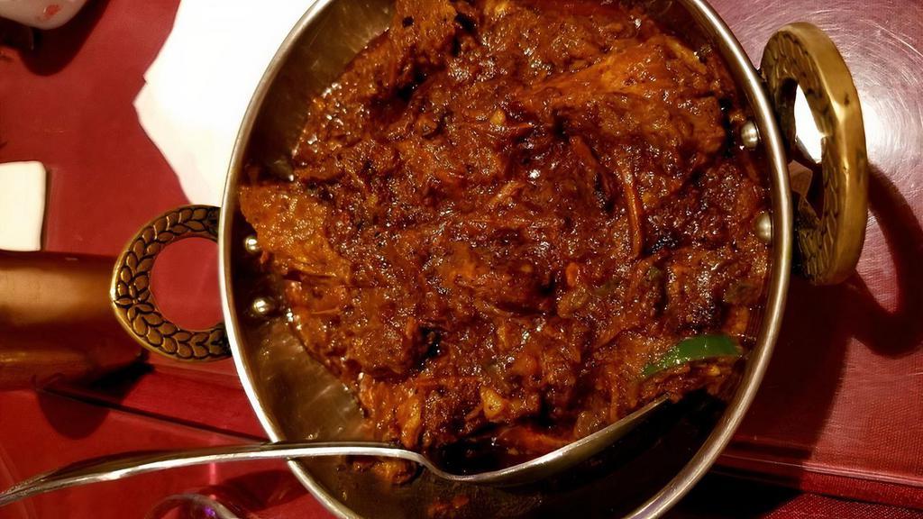 Rogan Ghost · Tender pieces of lamb or goat sautéed in thick onion gravy with garlic, tomatoes and fresh ground spices.