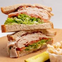 Turkey Blt Sandwich · Turkey, bacon, lettuce, tomato, and mayonnaise. Served with pickle and side of macaroni, pot...