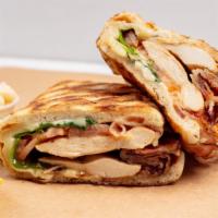 Chicken On The Sun Panini · Grilled chicken, bacon, Swiss cheese, baby spinach, tomato, and creamy Italian. Served with ...