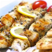 Chicken Souvlaki · Greek traditional pita served with red onion, tomato, lettuce, french fries wrapped in warm ...