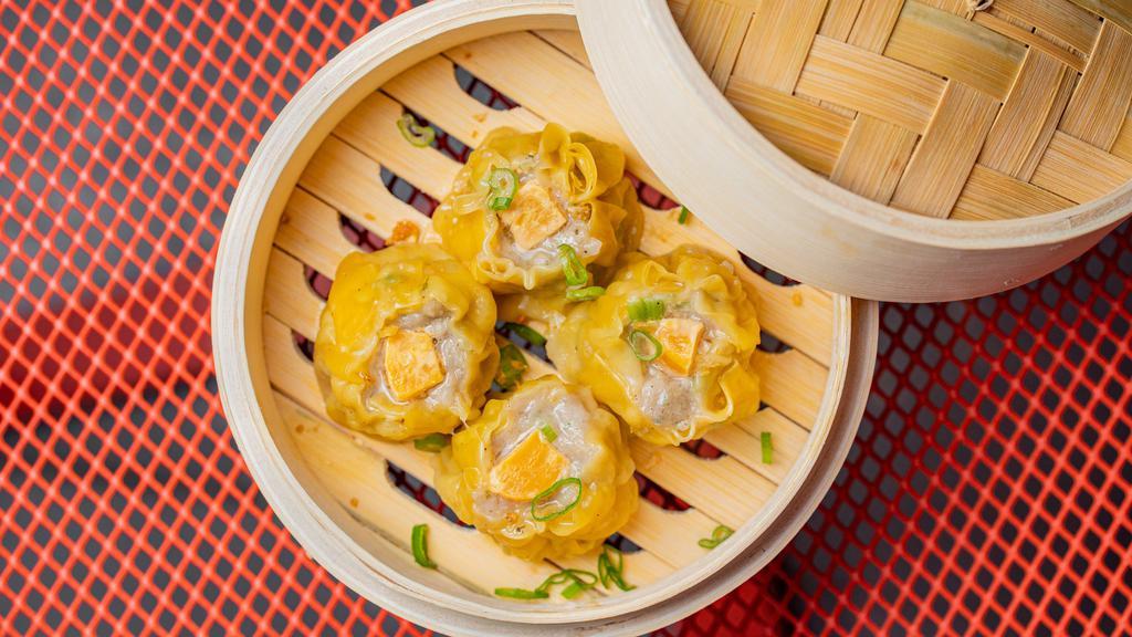 Chicken Dumplings (4 Pcs) · (4 pcs) Chicken, salted egg yolk, garlic, scallions, and cilantro  topped with scallions and fried garlic.. Contains: Wheat gluten, egg.