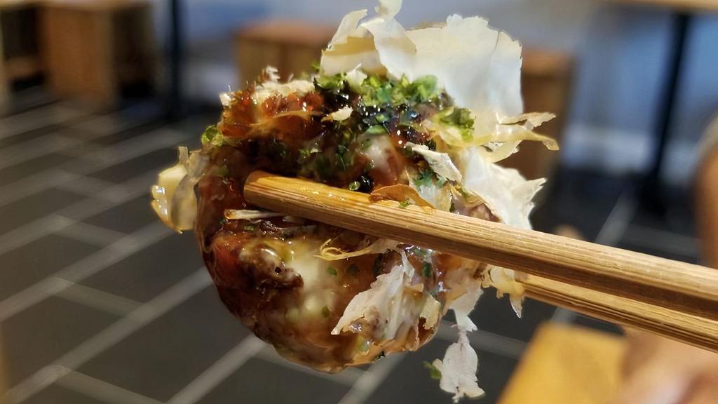 Takoyaki (Octopus Ball) · 4 Jumbo Octopus ball topped with sweet wasabi mayo, eel sauce, smoked tuna flakes and sprinkle seaweed.