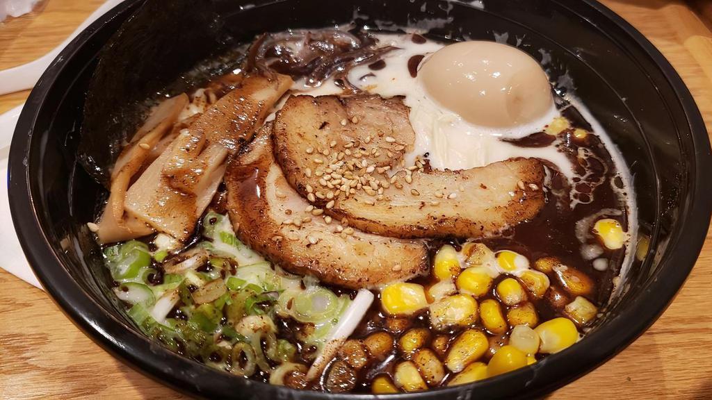 Tonkotsu  · Pork bone stock, thin straight  noodle. Full flavor creamy texture. topped  with 2 sliced grilled chashu (braised pork belly), 1/2 seasoned soft boiled egg, bamboo shoots, sweet organic corn, woodear mushroom, black garlic oil, and sesame seeds.