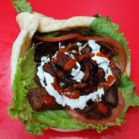 Lamb Gyro · Serve with white sauce, hot sauce, lettuce, tomatoes, fry onion, and peppers.