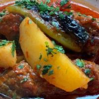Izmir Kofte · Cumin spiced ground lamb in tomato sauce with potatoes and peppers. Served with side of Turk...