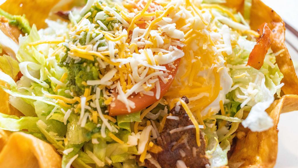 Taco Salad Lunch · Crispy flour tortilla with melted cheese, chicken or ground beef, lettuce, tomatoes and sour cream.