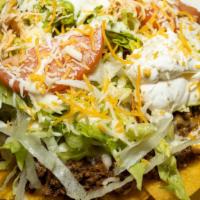 Nachos Supreme · Nachos with cheese, beef, chicken and beans, topped with lettuce, tomatoes, sour cream and g...