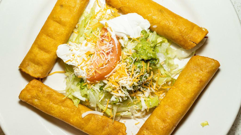 Taquitos Mexicanos · Four fried corn taquitos with chicken, lettuce, guacamole, tomatoes and sour cream.