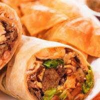 Steak & Chicken Burrito · Mexican rice, pinto beans, lettuce, Monterrey jack cheese, sour cream, and salsa roja wrappe...