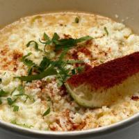 Elote Desgranado · Shredded corn with roasted garlic & jalapeno mayo, topped with tajin, queso fresco, cilantro...