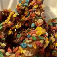 Rainbow Churros · Delicious homemade churros topped with glazed caramel and fruity pebbles accompanied by stra...