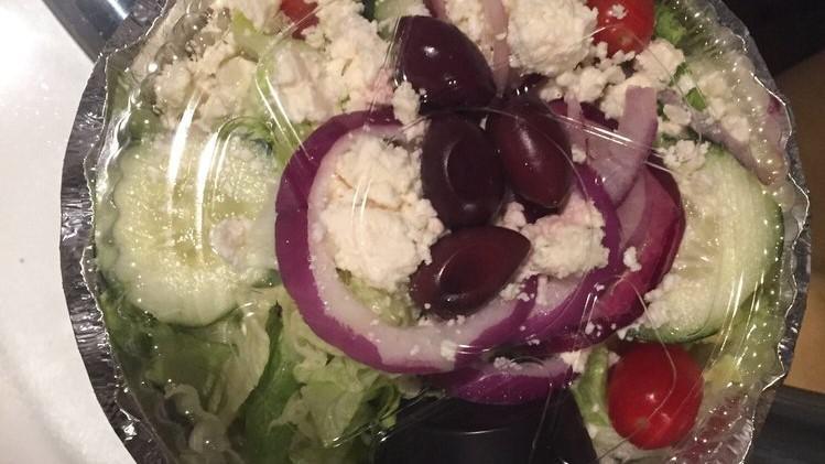 Greek Salad · Crisp iceberg lettuce topped with crumbled feta cheese, stuffed grape leaves, kalamata olives, pepperoncini, red onions, cucumber and tomatoes. served with Greek dressing.