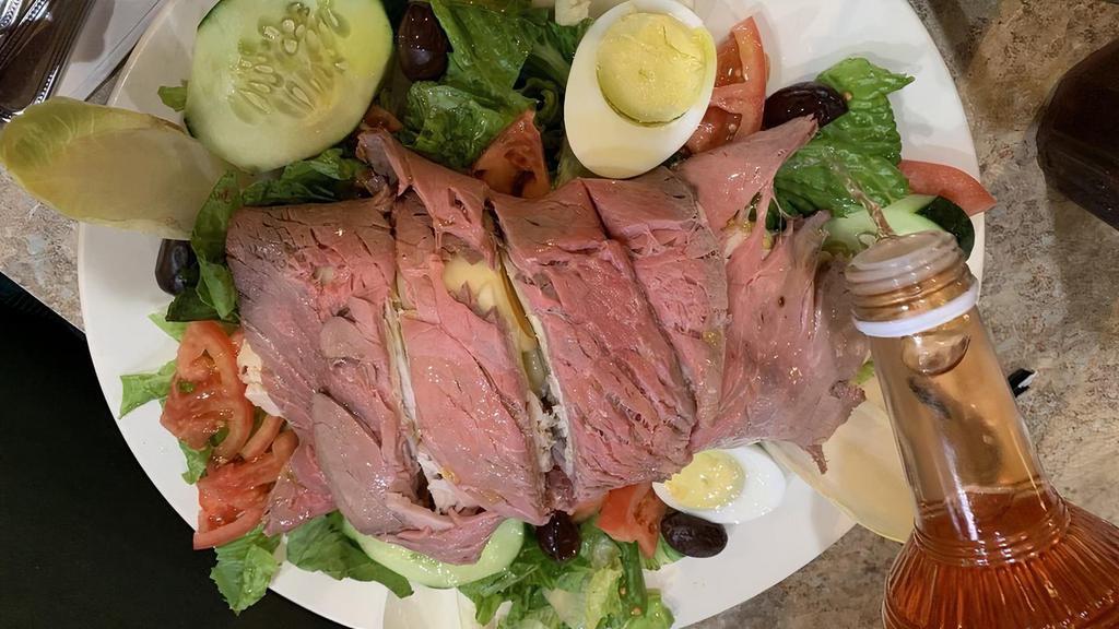 Chef Salad · Crisp iceberg lettuce, sliced breast of turkey, roast beef, boiled ham, swiss cheese, cucumbers, tomatoes, hard boiled eggs, black olives and your choice of dressing.