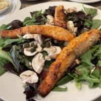 Grilled Salmon Salad · Grilled salmon over mixed greens, sundried tomatoes, fresh capers, mushrooms in garlic-lemon...