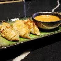 S.A. Gyoza · 6 pieces - Pan-Fried Fresh Pork Gyoza | Served with Spicy Peanut Sauce (Sauce Contains Nuts).