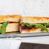 Grass Sandwich · Roasted beets, honey butternut squash mash, fried goat cheese and arugula on flautto.