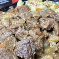 Curry Goat · Served with your choice of rice or Rasta pasta and a choice of garden salad or steamed veget...