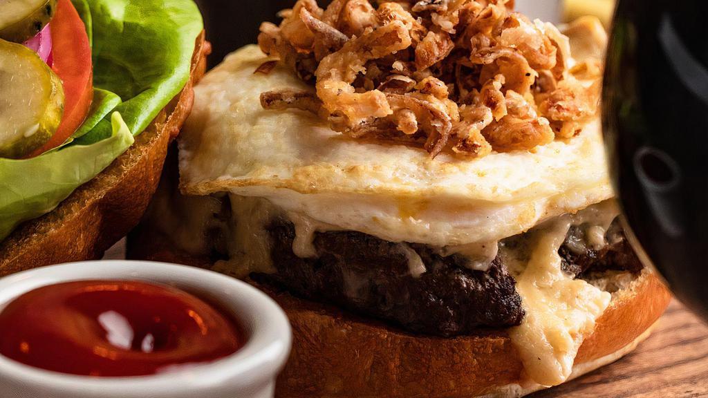 The Signature · Beef or lamb burger towered high w/ fried egg, crispy onion. IPA—cheese combo sauce.