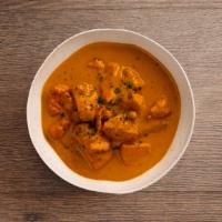 Butter Chicken (Makhani) · Boneless tandoori chicken cooked in a tomato and butter sauce.