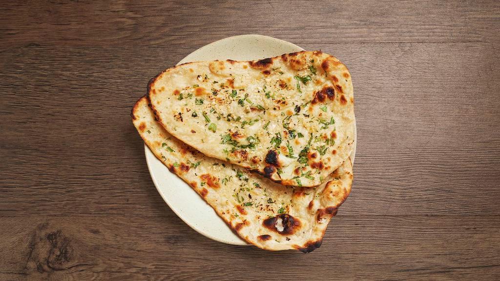 Garlic Naan · Oven-baked flatbread topped with garlic.