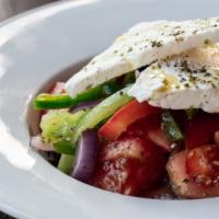 Horiatiki · Vegetarian. Classic Greek salad, vine-ripened tomatoes, cucumbers, red onions, olives, peppe...