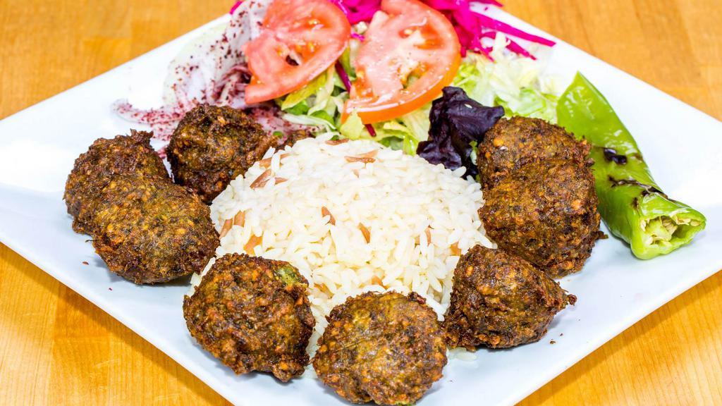 Falafel Over Rice · Delicious falafel fritters with cucumber mix over delicious rice.