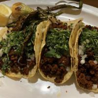 Tacos · 3x handmade corn tortillas, served with onions and cilantro.