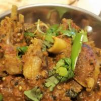 Goat Karahi · Goat dish stir - fried with spices, chilis, and tomatoes. (1 Pound)