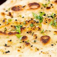 Garlic Naan · A flatbread topped with garlic and made in a tandoori oven. (per naan)