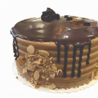 Mocha Cake · Vanilla cake soaked in coffee syrup with mocha buttercream topped with sliced almonds.