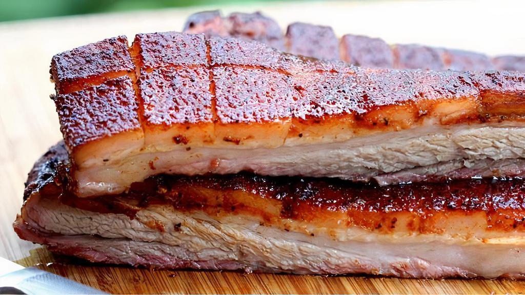 Bbq Pork Belly · Melt-in-your-mouth hickory and mesquite smoked pork belly.  Note:  high fat content, red smoke ring may exist, the meat is fully cooked.