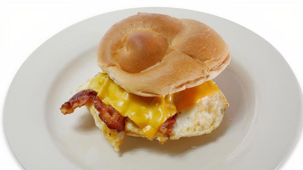 Breakfast Sandwich · Fried egg with meat and cheese served on toast.