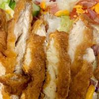 Krispy Chicken Salad · Mixed greens with fried chicken strips, tomatoes, bacon, cucumbers, onions and cheddar cheese.