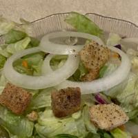 Tossed Salad · Mixed greens with tomato, cucumber, onions, and croutons with dressing.
