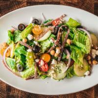 The Antipasto Salad · Fresh crisp romaine lettuce topped with fresh diced tomato, sweet red onion, black olives, s...