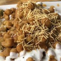 Papdi Chaat · A combination of crispy chips, chanay, onions and herbs seasoned in spicy yogurt, mint chutn...