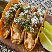 Chicken Tacos · Three white meat chicken tacos served with white onions, cilantro, lime wedges, topped with ...