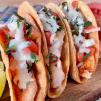 Shrimp Tacos · Three grilled shrimp tacos topped with pico de gallo, cilantro, and your choice of sauce. Se...