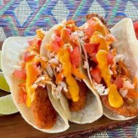 Flounder Fish Tacos · Three fried flounder fish tacos topped with finely chopped cabbage, carrots and tomatoes. Se...