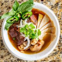 Central Vietnamese Style Spicy Beef Noodle Soup (Bún Bò Huế) · Popular dishes.  Served with beef shanks, pig's feet,  steamed pork ham,  and Vietnamese sty...