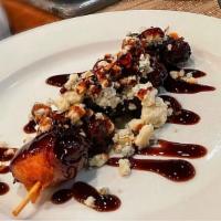 Bacon-Wrapped Stuffed Dates (5) · Gluten Free. Dalmatian Cheese, Balsamic Drizzle, Crumbled Blue Cheese