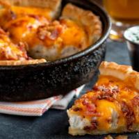 Pizza Skins® · Our famous deep dish pizza crust stuffed with red bliss mashed potatoes and topped with baco...