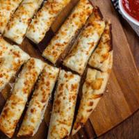 Cheesy Garlic Bread · Uno’s pizza dough topped with lots of garlic and mozzarella cheese, baked and served with ho...