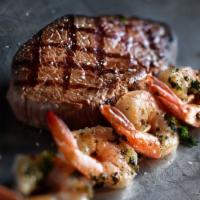 Grilled Shrimp & Sirloin · A 10oz USDA choice top sirloin and a skewer of shrimp basted in a basil and garlic marinade.