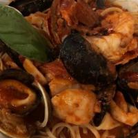 Seafood Pescatore · Shrimp, scallops, clams, mussels, calamari, lobster, plum tomato sauce, and linguine.