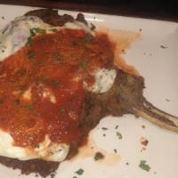 Veal Chop Parmigiana · Melted mozzarella, marinara, basil, and linguine.