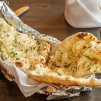 Garlic Naan · Naan stuffed with seasoned onion and baked in a traditional clay oven.