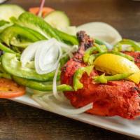 Tandoori Chicken · Dark meat chicken marinated in yogurt and spices, roasted in our traditional clay oven.