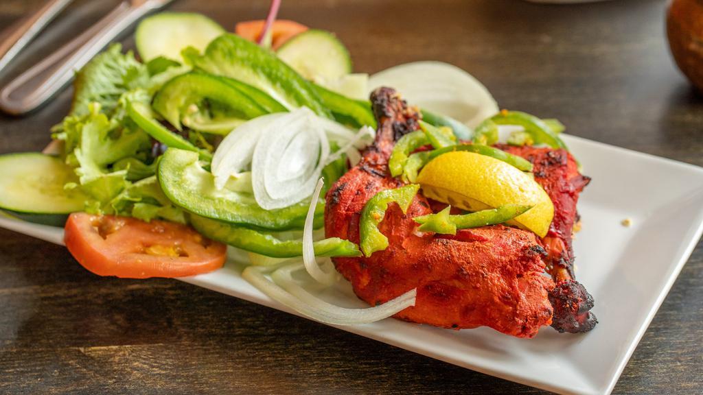Tandoori Chicken · Dark meat chicken marinated in yogurt and spices, roasted in our traditional clay oven.