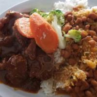 Bistec T Bone Con Langosta · T bone steak with lobster. Served with rice and beans or green or yellow plantain or french ...